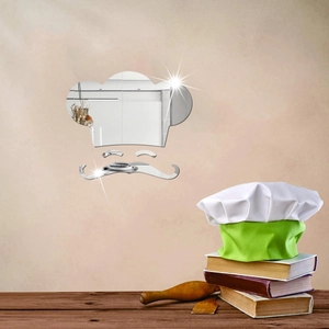 Detail of chef hat and mustache mirror wall stickers on a textured kitchen wall