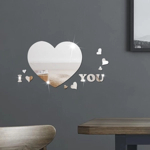 Detail of mirrored acrylic heart wall stickers with I love you letters on dark wall