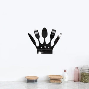 Macro detail of black acrylic mirror crown wall sticker with cutlery and star cutouts
