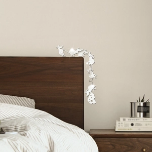 Detail of silver acrylic mirror mouse and cheese wall decals on bedroom corner
