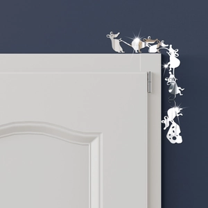 Detailed view of silver mirror acrylic mouse wall stickers on a white door corner