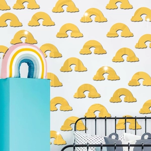 Close-up of yellow rainbow acrylic mirror wall stickers in a cozy bedroom setting