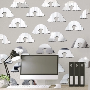 Macro shot of rainbow-shaped acrylic mirror stickers on a minimalist office wall decoration