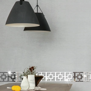 Detail of silver mirrored acrylic wall border with geometric Greek key pattern and reflections