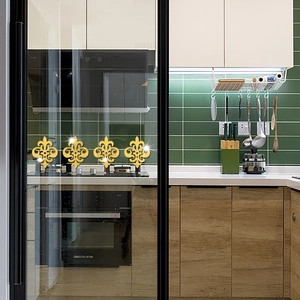 Detail of four golden Fleur-de-lis mirror wall stickers on a black framed glass door