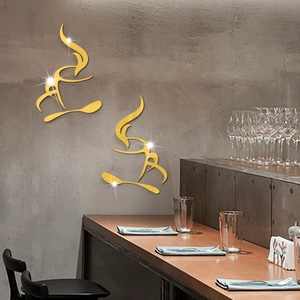 Detail showing two golden acrylic coffee cup mirror wall stickers on a modern grey wall