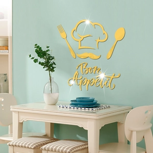 Macro detail of golden acrylic mirror chef hat and Bon Appétit wall sticker