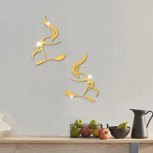 Close-up of golden acrylic mirror coffee cup wall stickers reflecting light on a grey wall