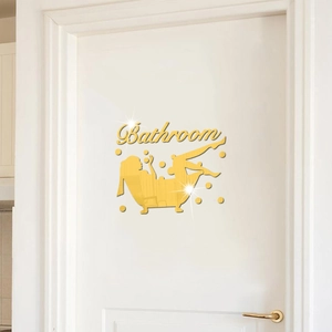 Detailed view of golden mirror bathroom wall sticker with silhouette on white door
