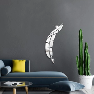 Detailed view of feather-shaped acrylic mirror wall stickers on a dark grey living room wall
