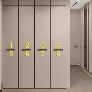 Modern minimalist dark bronze door handles installed on light grey wardrobe cabinets