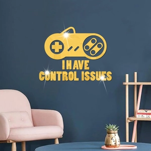Detail of golden acrylic game controller wall sticker with I Have Control Issues text
