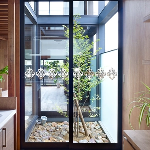 Set of 8 silver mirror acrylic fleur-de-lis stickers applied on modern glass sliding doors