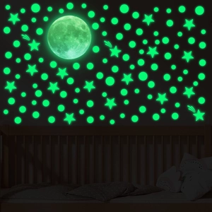 Luminous wall stickers featuring a large moon and stars glowing in the dark for bedroom decor