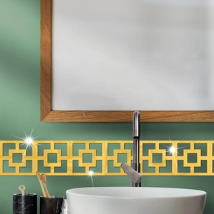 Detail of gold Greek key mirror wall sticker on a green bathroom wall border