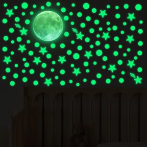 Glow in the dark wall stickers showing a luminous moon and stars for bedroom decor