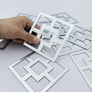 Close-up of peeling protection film from silver acrylic mirror wall sticker with adhesive back