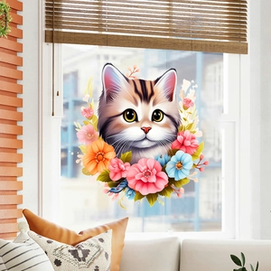 Cartoon kitten in floral wreath wall sticker displayed on a bright living room window