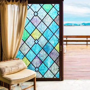 Detail of stained glass privacy film with colored diamond patterns on balcony doors