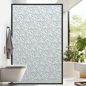 Detail of frosted glass privacy film with pebble texture and modern black frame