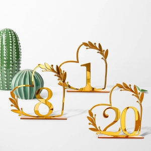 Golden mirror acrylic heart-shaped table numbers with elegant leaf design for weddings