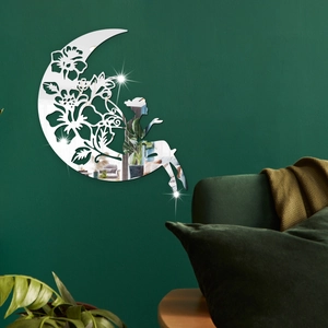 Detail of silver acrylic moon fairy mirror wall sticker on a dark green textured wall