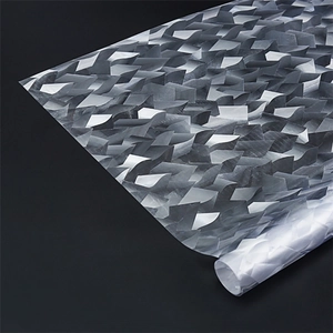 Close-up of 3D geometric scale texture on static privacy glass film in silver grey