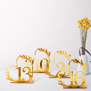 Golden mirror acrylic heart-shaped wedding table number with elegant leaf details