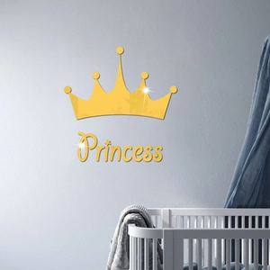 Detail of gold mirror acrylic crown wall decal with Princess text in a cozy nursery room