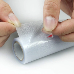 Close-up of frosted privacy glass film roll with red arrow marker for easy peeling