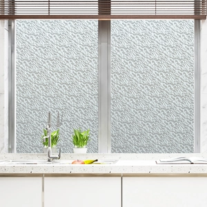 Detail of static cling stained glass privacy film with textured stone pattern in a kitchen
