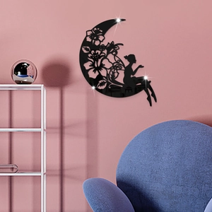 Detail of black acrylic moon fairy wall sticker with flower cutouts on pink wall