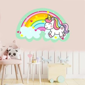 Detailed view of glowing unicorn and rainbow wall decals on a soft pink nursery wall