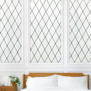 Detail of frosted window film with black diamond pattern on a bedroom glass pane