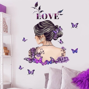 Detail of purple rose and butterfly wall sticker with LOVE text on a bedroom wall