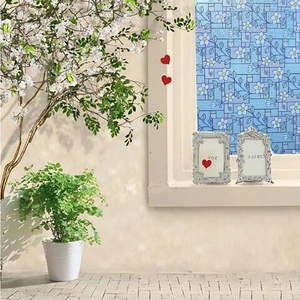 Detail view of floral frosted glass film with blue grid and white flower patterns