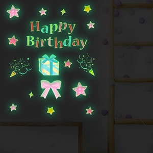 Glow-in-the-dark Happy Birthday wall stickers with stars and gift box in a dark room
