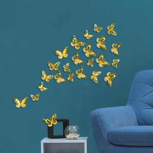 Close-up of golden 3D hollow butterfly wall stickers with metallic reflective finish