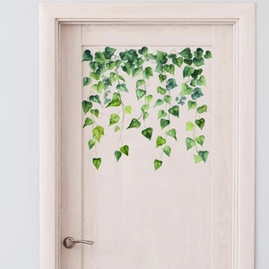Realistic green vine wall decals showing hanging ivy leaves on a wooden door background
