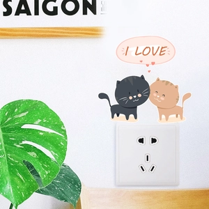 Detail showing cute black and yellow cat wall stickers above a light switch