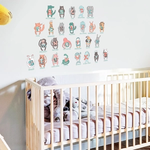 Detailed view of educational animal alphabet wall decals in a modern white nursery setting