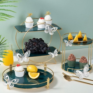 Macro view of 3D silver hollow butterfly stickers on a party cake stand and dessert tray