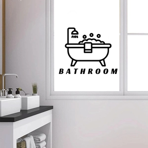 Detail view of a black self-adhesive bathroom wall sticker on a glass door surface