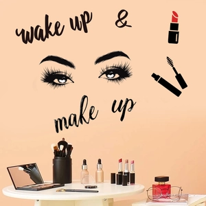 Detail of wake up & make up wall decal with eyelashes above a vanity with cosmetics
