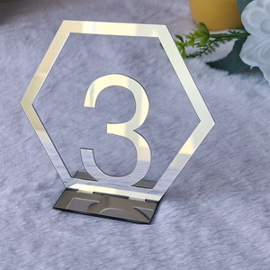 Close-up of hexagonal silver acrylic mirror table number three with matching base