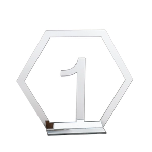 Close-up of hexagonal acrylic mirror wedding table number one with standing base