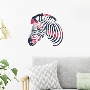 Artistic zebra wall sticker with pink roses and blue scrolls displayed above a grey sofa