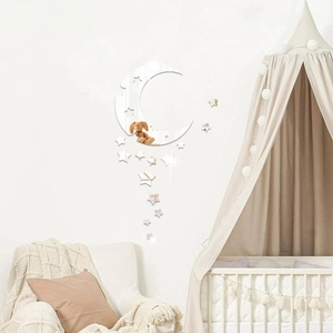 Close-up of moon and stars acrylic mirror wall stickers in a cozy nursery room setting