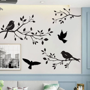 Close-up of black bird and tree branch silhouette wall stickers in a modern living room