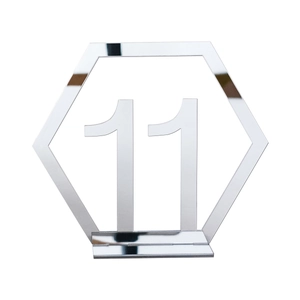 Macro detail of silver mirror acrylic hexagon table number eleven with support base